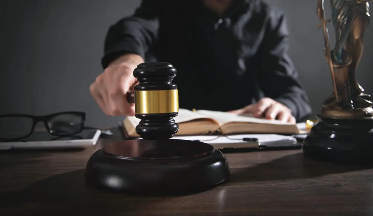 Gavel representing fines and criminal penalties for unlicensed contracting in California.