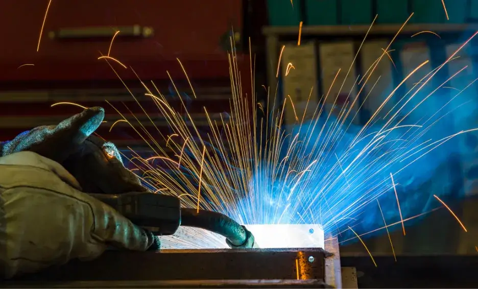 Licensed C60 contractor welding two pieces of steel.