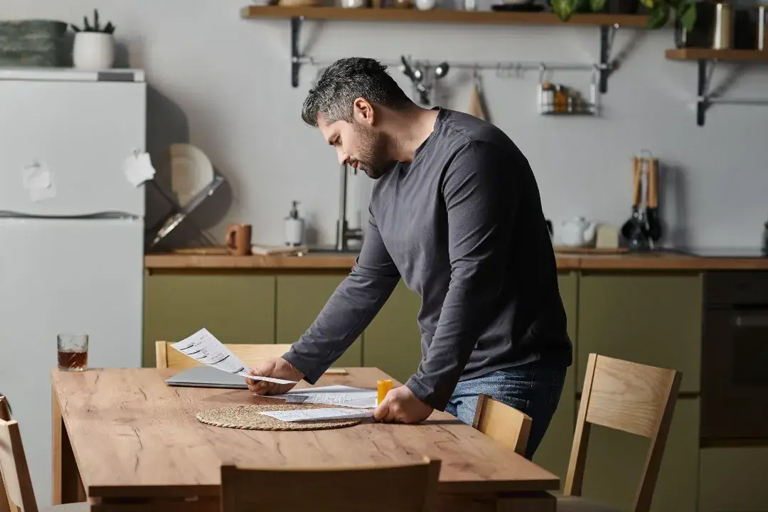 Sole proprietor reviewing business paperwork before applying for a California contractor license.