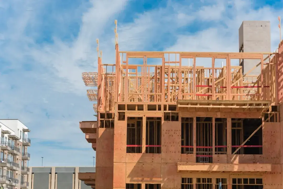 Wood framing of a multi-story apartment building under construction, representing structural framing experience for B-General qualification.